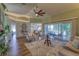 Bright living room with wood flooring, stylish furniture, and sliding doors to an outdoor patio at 3295 Hibiscus Dr, Hernando Beach, FL 34607