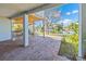 Charming outdoor patio overlooking waterfront, featuring a brick floor, staircase, and peaceful views of the serene lake at 3295 Hibiscus Dr, Hernando Beach, FL 34607