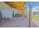 Outdoor patio with a brick floor, showing the stairs to the upper level and the location of the hot tub at 3295 Hibiscus Dr, Hernando Beach, FL 34607