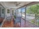 Relaxing screened-in patio with a ceiling fan and views of the outdoors with comfortable chairs and an appealing tile floor at 3295 Hibiscus Dr, Hernando Beach, FL 34607