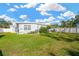 Large backyard with grassy lawn and partial view of home at 4008 W Wyoming Ave, Tampa, FL 33616