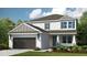 Two-story home with gray siding, brown garage door, and landscaping at 5134 Slate Hue Pl, Apollo Beach, FL 33572