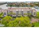 Aerial view of waterfront condo building with lush landscaping and boat slips at 6260 Kipps Colony Ct # 204, Gulfport, FL 33707