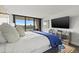 Main bedroom with water view, large TV, and comfortable bedding at 6260 Kipps Colony Ct # 204, Gulfport, FL 33707
