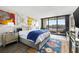 Spacious bedroom with water views and eclectic wall art at 6260 Kipps Colony Ct # 204, Gulfport, FL 33707