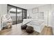Bright bedroom with white furniture and balcony access at 6260 Kipps Colony Ct # 204, Gulfport, FL 33707