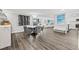 Open concept dining room with hardwood floors and wine storage at 6260 Kipps Colony Ct # 204, Gulfport, FL 33707