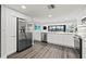 Modern kitchen with stainless steel appliances and white cabinets at 6260 Kipps Colony Ct # 204, Gulfport, FL 33707