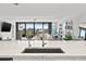 Modern kitchen with white cabinets, quartz countertops and a view at 6260 Kipps Colony Ct # 204, Gulfport, FL 33707