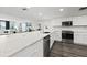Modern kitchen with white cabinets, quartz countertops, and stainless steel appliances at 6260 Kipps Colony Ct # 204, Gulfport, FL 33707