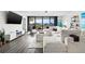 Bright living room with water views, sectional sofa, and hardwood floors at 6260 Kipps Colony Ct # 204, Gulfport, FL 33707