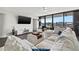 Bright living room with water views, sectional sofa, and hardwood floors at 6260 Kipps Colony Ct # 204, Gulfport, FL 33707