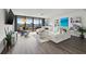 Bright living room with water views, sectional sofa, and hardwood floors at 6260 Kipps Colony Ct # 204, Gulfport, FL 33707