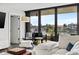 Bright living room with water views, sectional sofa, and hardwood floors at 6260 Kipps Colony Ct # 204, Gulfport, FL 33707