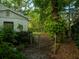 View of partially fenced backyard with large tree at 637 Jamaica Ave, Tampa, FL 33606