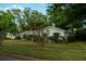 Well-maintained single-Gathering home with a green lawn, mature shrubs, and a welcoming facade at 637 Jamaica Ave, Tampa, FL 33606