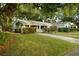 Charming single-story home with a lush green lawn and mature trees offering ample shade at 637 Jamaica Ave, Tampa, FL 33606