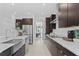 Open concept kitchen with island, stainless steel appliances, and white quartz countertops at 741 58Th Ne Ave, St Petersburg, FL 33703