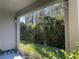 Private backyard with lush greenery and a covered patio at 10058 Corso Milano Dr, Tampa, FL 33625