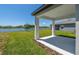 This backyard features a covered patio overlooking a lake at 10533 Hidden Banks Gln, Parrish, FL 34219