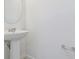 This bathroom features a pedestal sink with an oval mirror and a chrome towel bar at 10533 Hidden Banks Gln, Parrish, FL 34219