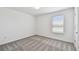 This spacious bedroom features neutral carpeting and a window overlooking the backyard at 10533 Hidden Banks Gln, Parrish, FL 34219