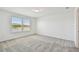 This spacious bedroom features neutral carpeting and a window overlooking the backyard at 10533 Hidden Banks Gln, Parrish, FL 34219