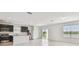 Modern kitchen with stainless steel appliances, dark cabinets, an island, and a view of the outdoors through sliding glass doors at 10533 Hidden Banks Gln, Parrish, FL 34219