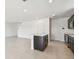 Open-concept kitchen with an island, stainless steel appliances, and dark cabinetry, seamlessly connected to the living area at 10533 Hidden Banks Gln, Parrish, FL 34219