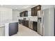 Spacious kitchen featuring stainless steel appliances, dark wood cabinetry, and ample countertop space, perfect for cooking at 10533 Hidden Banks Gln, Parrish, FL 34219