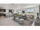 Bright, open-concept living area boasts modern finishes, neutral tones and great natural light with kitchen view at 10533 Hidden Banks Gln, Parrish, FL 34219