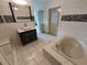 Updated bathroom with a bathtub, shower, and modern vanity at 1182 Norwood Ave, Clearwater, FL 33756