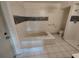 Bright bathroom featuring tiled flooring, mosaic accents and a combination tub/shower at 1182 Norwood Ave, Clearwater, FL 33756