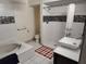 Well-lit bathroom showcasing a bathtub, shower, and modern vessel sink at 1182 Norwood Ave, Clearwater, FL 33756