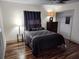 Cozy bedroom featuring sleek wood floors and a comfortable bed with stylish furnishings at 1182 Norwood Ave, Clearwater, FL 33756