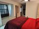 Spacious bedroom featuring an ensuite bathroom and a comfortable seating area by the window at 1182 Norwood Ave, Clearwater, FL 33756