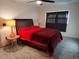 Cozy bedroom featuring a ceiling fan, plush carpet, and bedside tables with lamps at 1182 Norwood Ave, Clearwater, FL 33756
