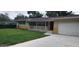 Charming single-story home with well-maintained lawn and inviting front entrance at 1182 Norwood Ave, Clearwater, FL 33756