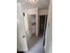 Hallway featuring carpeted floors and open closet with shelving at 1182 Norwood Ave, Clearwater, FL 33756