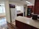 The kitchen has stainless steel appliances, wooden cabinets, and granite countertops at 1182 Norwood Ave, Clearwater, FL 33756
