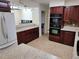 The kitchen has stainless steel appliances, wooden cabinets, and countertops at 1182 Norwood Ave, Clearwater, FL 33756