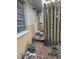 Side yard with steps leading to a door and wooden fence at 1182 Norwood Ave, Clearwater, FL 33756