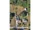 An aerial shot showcases the entire property, including a pool, sheds, house, and surrounding landscape at 11945 Carmen Ave, Dade City, FL 33525