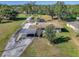 Aerial view featuring a large lot, a carport, and a screened-in pool at 11945 Carmen Ave, Dade City, FL 33525