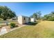 The backyard area includes well-kept grass, a white picket fence, and a shed, enhancing the property's appeal at 11945 Carmen Ave, Dade City, FL 33525