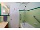 Bathroom features green tile, a bathtub, and accessible shower features at 11945 Carmen Ave, Dade City, FL 33525