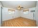 Bright bedroom with wood laminate flooring, neutral walls, and ample natural light at 11945 Carmen Ave, Dade City, FL 33525