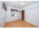 Bright bedroom featuring hardwood floors, a ceiling fan, and a window providing natural light at 11945 Carmen Ave, Dade City, FL 33525