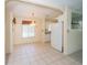 Bright dining area featuring tiled flooring, chandelier lighting, and convenient kitchen access at 11945 Carmen Ave, Dade City, FL 33525