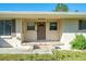 Charming front porch with decorative planters and a well-manicured lawn at 11945 Carmen Ave, Dade City, FL 33525